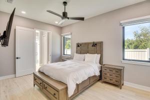 a bedroom with a bed and a ceiling fan at Walk to Shore Modern Stunner in Ormond Beach! in Ormond Beach +21 photos