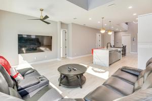 a living room with a couch and a table at Walk to Shore Modern Stunner in Ormond Beach! in Ormond Beach