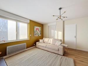a living room with a couch and a window at Coup de cœur in Grande-Synthe