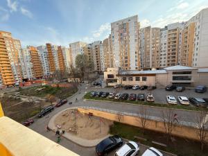 a view of a parking lot in a city with tall buildings at Cozy Two Bedroom Large Apartment in Chişinău