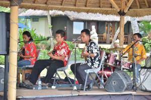 a group of people playing music on a stage at Pool Villa Merumatta Senggigi in Senggigi