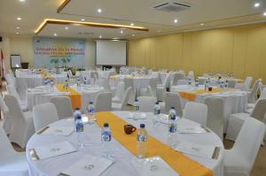 a conference room with white tables and chairs and water bottles at Pool Villa Merumatta Senggigi in Senggigi +30 photos