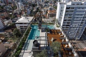 an apartment with a swimming pool on the side of a building at GO Rio Branco by Rezervo in Partenon +25 photos
