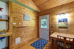 a log cabin with a table and chairs in a room at Making lasting memories while enjoying this unique glamping experience in Maple Falls