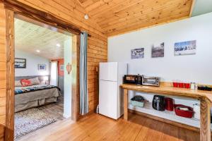 a kitchen with a refrigerator and a bed in a room at Making lasting memories while enjoying this unique glamping experience in Maple Falls
