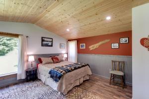 a bedroom with a bed and a window and a chair at Making lasting memories while enjoying this unique glamping experience in Maple Falls