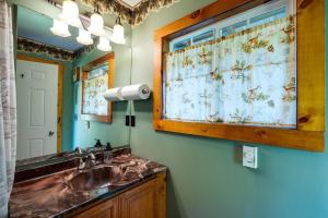a bathroom with a sink and a large mirror at Making lasting memories while enjoying this unique glamping experience in Maple Falls