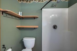 a bathroom with a white toilet and a shower at Making lasting memories while enjoying this unique glamping experience in Maple Falls