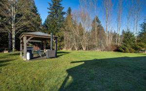 a gazebo in the middle of a grass field at Making lasting memories while enjoying this unique glamping experience in Maple Falls
