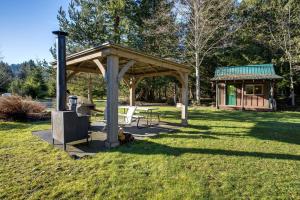 a picnic shelter and a picnic table in a park at Making lasting memories while enjoying this unique glamping experience in Maple Falls