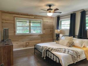 a bedroom with a bed and a ceiling fan at Decatur Home - Chic Comfort Family & Fun in Decatur