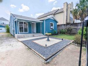 a blue house with a garden in front of it at 2 Bedroom 2 Bathroom Inside the Loop in Houston