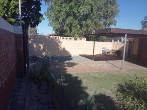 a backyard with a fence and a pavilion at ATHOME BELLVILLE Chrismar in Cape Town