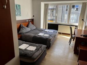 Postel nebo postele na pokoji v ubytování Hotel Tenova Köln-Neumarkt