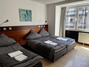 Postel nebo postele na pokoji v ubytování Hotel Tenova Köln-Neumarkt
