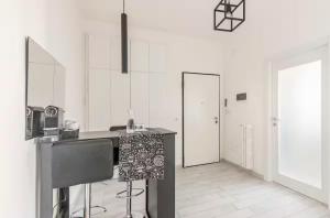 a kitchen with white walls and a counter in a room at Casa centro vista mare in Sassari +8 photos