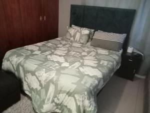 a messy bed with a laptop on top of it at ATHOME BELLVILLE Chrismar in Cape Town +16 photos