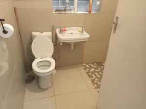 a bathroom with a toilet and a sink at ATHOME BELLVILLE Chrismar in Cape Town