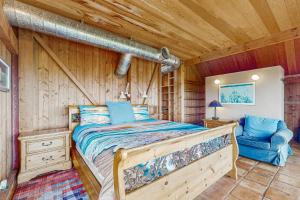 a bedroom with a bed and a chair in a room at Compass Rose in Sea Ranch +27 photos