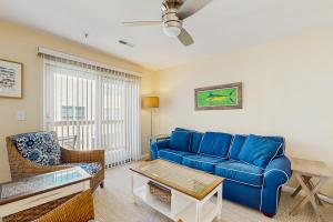 a living room with a blue couch and chairs at Rainbow Cove --- 117 Dagsworthy Ave #B in Dewey Beach