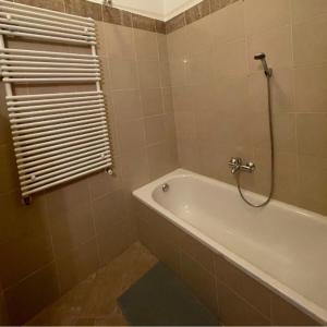 a bathroom with a bath tub and a shower at Klikk Apartments at Gozsdu in Budapest +8 photos