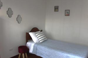 a bedroom with a bed with two pillows on it at Aero Hostal in Santiago