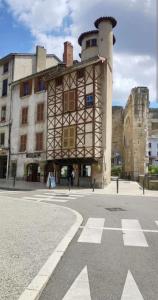 a building with a tower on the side of a street at Appart'Hôtel du Cloître in Vienne +41 photos