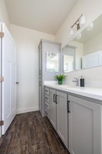 a white bathroom with a sink and a mirror at Gateway Getaway in Williams