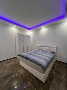a bedroom with a bed with a purple ceiling at Oberhausen Mitte in Oberhausen