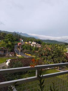 a view of a road in a town with trees at Uthe house in Pacet +3 photos