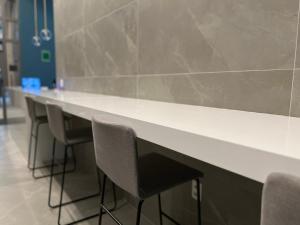 a row of chairs sitting at a counter in a room at NOVO - Studio aconchegante no Campo Belo in Sao Paulo