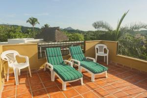 a group of chairs sitting on a balcony at Tranquil Home On Gringo Hill Sayulita in Sayulita