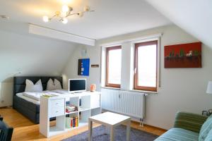 シュタイネンブロンにあるStayIN Apartment near Stuttgartのベッドとパソコン付きの机がある寝室