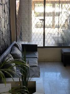 a living room with a couch and a window at Casa La Embajada in La Paz