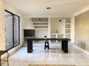 a ping pong table in a room with a large window at Casa La Embajada in La Paz