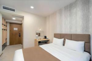 Postel nebo postele na pokoji v ubytování Hotel Flames