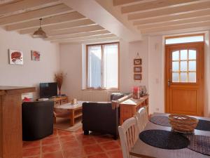 a living room with a table and a dining room at Parfait pour les amoureux de la nature: maison 2 chambres avec jardin, proche forêt et château - FR-1-581-74 in Senonches