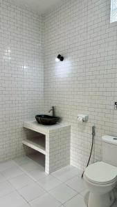 a bathroom with a sink and a toilet at Putu Homestay in Canggu