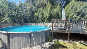a swimming pool with a deck and an umbrella at Kris Jordan C in Palm Bay +14 photos