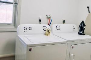 two white washing machines sitting next to a dishwasher at Country House in Waterbury +18 photos