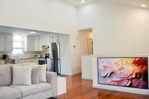 a living room with a couch and a painting on the wall at Country House in Waterbury