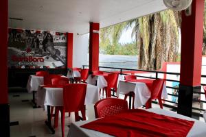 a restaurant with red and white tables and chairs at Bora Beach Club in Melgar