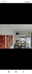 a kitchen and dining room with a table and chairs at Dpto con balcón in Olavarría