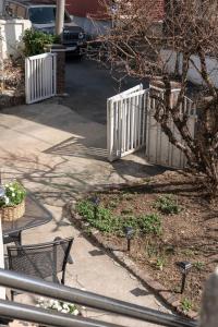 a white fence in front of a house at One House, a comforting place For someone going through a major turning point in Wabu