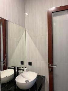 a bathroom with a white sink and a mirror at New 3BR Villa with Private Pool & Rooftop in Nusa Dua in Nusa Dua