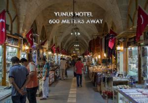 eine Gruppe von Menschen, die in einem Geschäft durch einen Markt gehen in der Unterkunft Yunus Hotel in Gaziantep