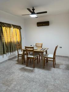 a dining room with a wooden table and chairs at NEKZA TEMPORARIOSs in Resistencia +5 photos