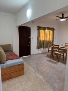 a bedroom with a bed and a table and chairs at NEKZA TEMPORARIOSs in Resistencia