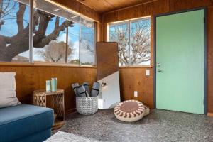 ジョシュア・ツリーにあるMoonrise Ranchの青いソファと野球のおもちゃが備わる客室です。