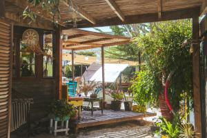 a porch of a house with a wooden deck at Aldea Bahiguana in Bahia Inglesa +15 photos